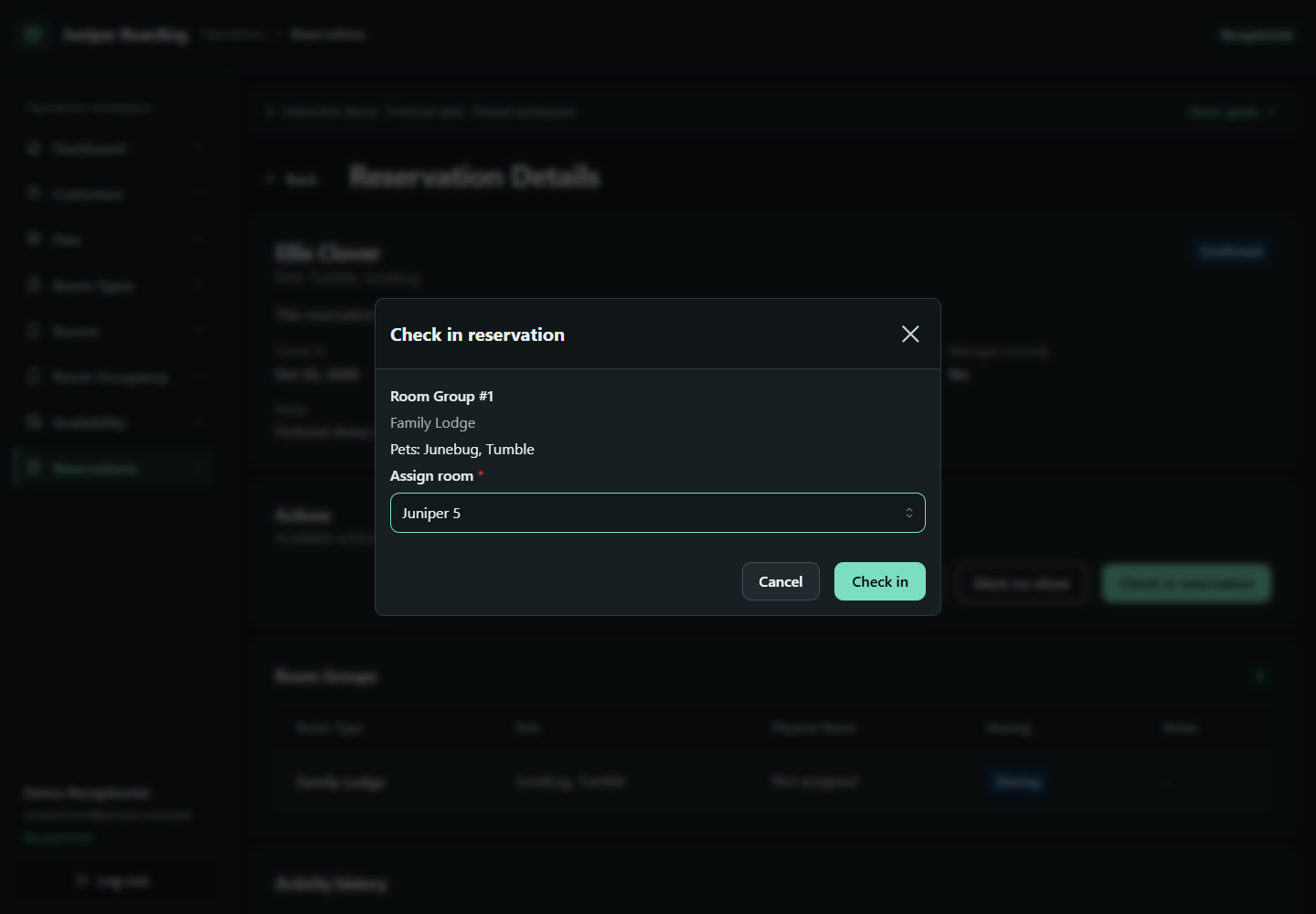 Juniper check-in dialog assigning a room to a reservation with two pets.